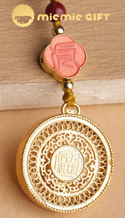 Close-up of the back design of the 12 Zodiac Lucky Charm Pendant, showcasing intricate golden engraving with auspicious Chinese symbols. Includes a hand-braided cord and vibrant faux cinnabar bead for added elegance and cultural significance.