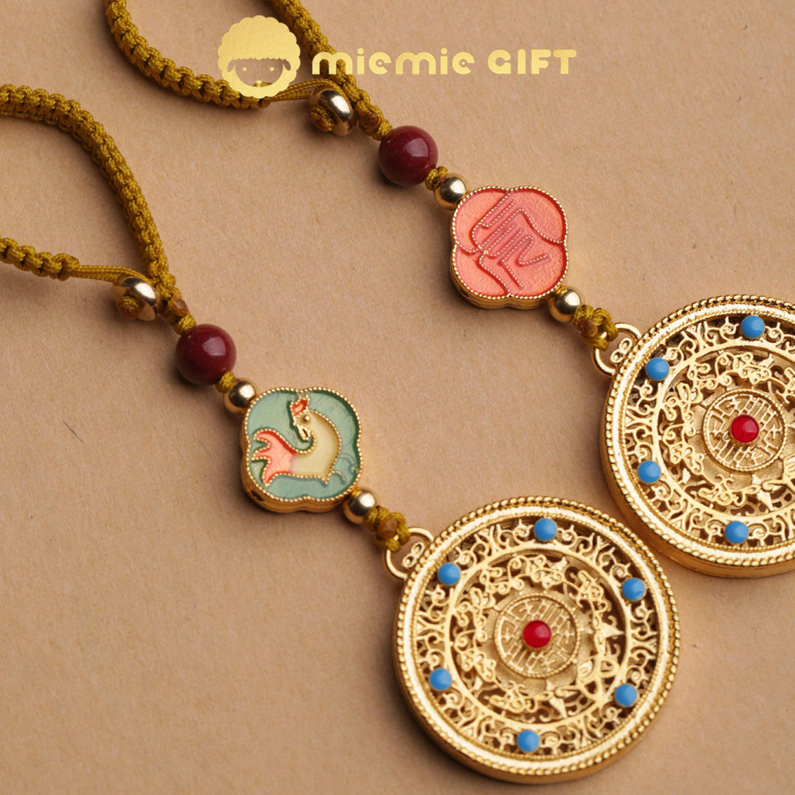 Close-up of 12 Zodiac Lucky Charm Pendant featuring intricate golden alloy design with a spinning disk, vibrant zodiac symbols, hand-braided cord, and faux cinnabar bead. A beautiful handcrafted accessory for attracting luck, prosperity, and harmony.