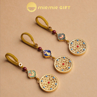 A set of three 12 Zodiac Lucky Charm Pendants featuring golden alloy spinning disks, colorful zodiac symbols, hand-braided cords, and faux cinnabar beads. Elegant handcrafted keychain accessories designed to attract luck, prosperity, and harmony.