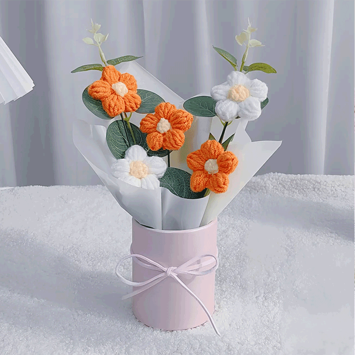 Knitted orange Daisy Charm A bouquet of hand-knitted daisies a symbol of Warmth and enthusiasm presented in a pink box with a ribbon