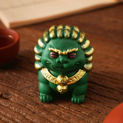 A green Peace Lion ornament with golden accents, symbolizing protection and harmony, displayed on a wooden surface with traditional elements in the background.