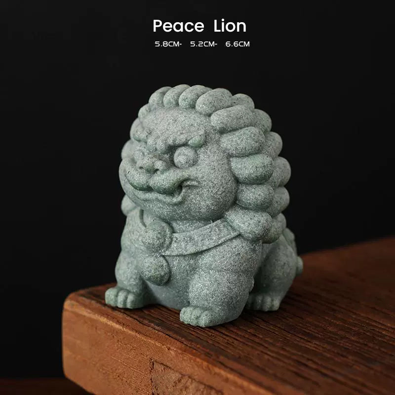 A green sandstone Peace Lion ornament with a textured finish, symbolizing protection and harmony, displayed on a wooden surface with its dimensions noted above.