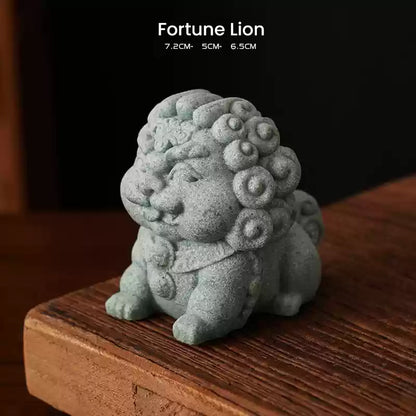 A Fortune Lion ornament crafted from green sandstone, symbolizing prosperity and success, displayed on a wooden surface with its dimensions noted above.