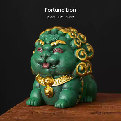 A green Fortune Lion ornament with intricate golden accents, symbolizing wealth and prosperity, displayed on a wooden surface with its dimensions listed above.