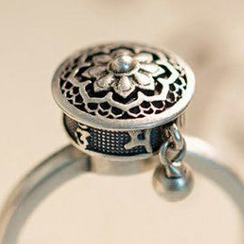 Elegant S925 sterling silver rotatable ring with intricate lotus flower design and dangling charm. Features a unique rotating mechanism for mindfulness and blessings.