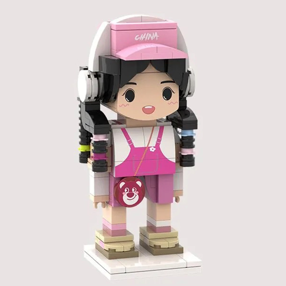 Custom brick figurine featuring a pink-themed outfit, including overalls, a cap with 'China' text, and playful accessories for a personalized look.