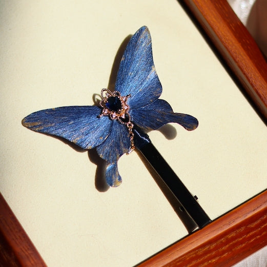 Handcrafted deep ocean blue velvet butterfly hair clip by Chujiu Mountain Atelier, featuring a delicate blue crystal centerpiece, golden accents, and a sleek clip design for versatile and elegant styling.