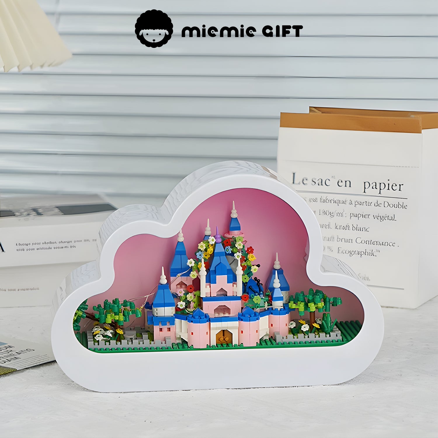 A full view of the DIY cloud castle nightlight, featuring a pastel pink interior and a delicate castle design with building blocks.