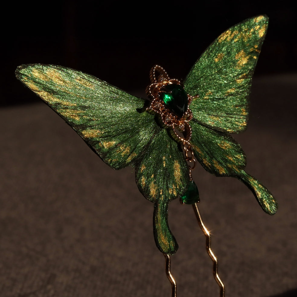 Elegant emerald green velvet butterfly hairpin handcrafted by Chujiu Mountain Atelier, featuring golden accents, a heart-shaped green crystal, and intricate wing details for a luxurious design.