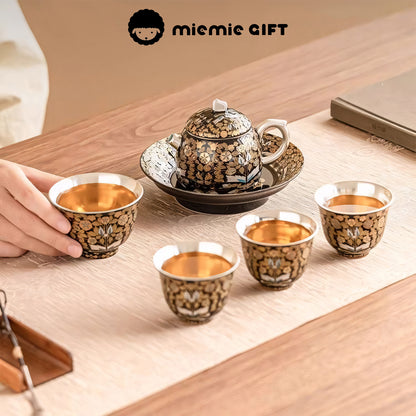 Golden Branches & Jade Leaves Gilded Silver Tea Set in use, showcasing four elegant cups filled with tea, accompanied by the intricately designed teapot and tray, blending cultural tradition with modern tea rituals.