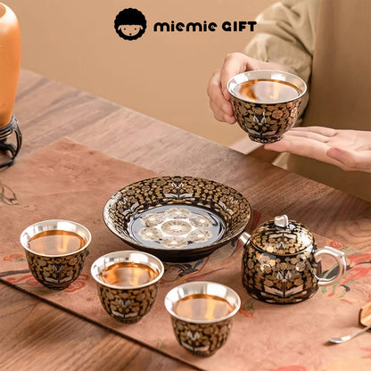 Golden Branches & Jade Leaves Gilded Silver Tea Set in a warm sharing moment, featuring a teapot, cups filled with tea, and a tray, highlighting its cultural elegance and perfect for tea rituals with loved ones.