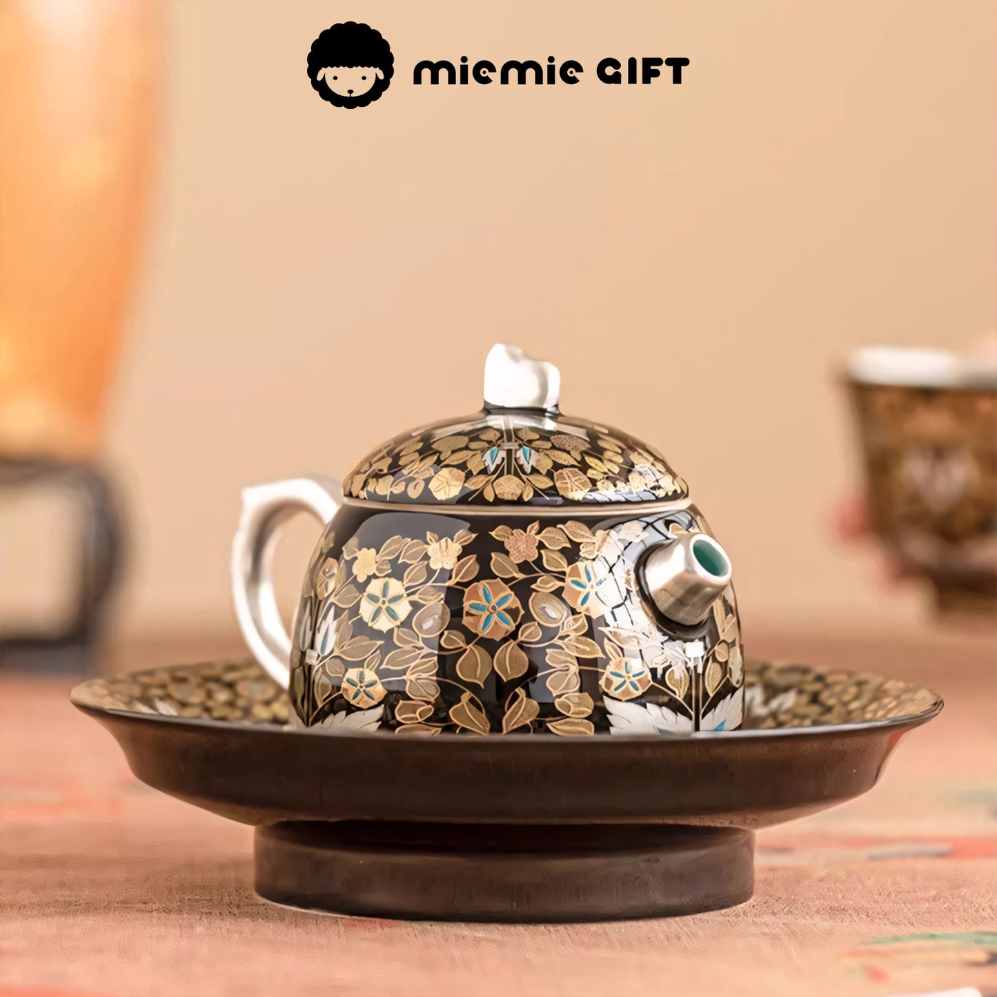 Close-up of the teapot from the Golden Branches & Jade Leaves Gilded Silver Tea Set, highlighting its intricate floral design, gold detailing, and elegant craftsmanship on a matching tray.