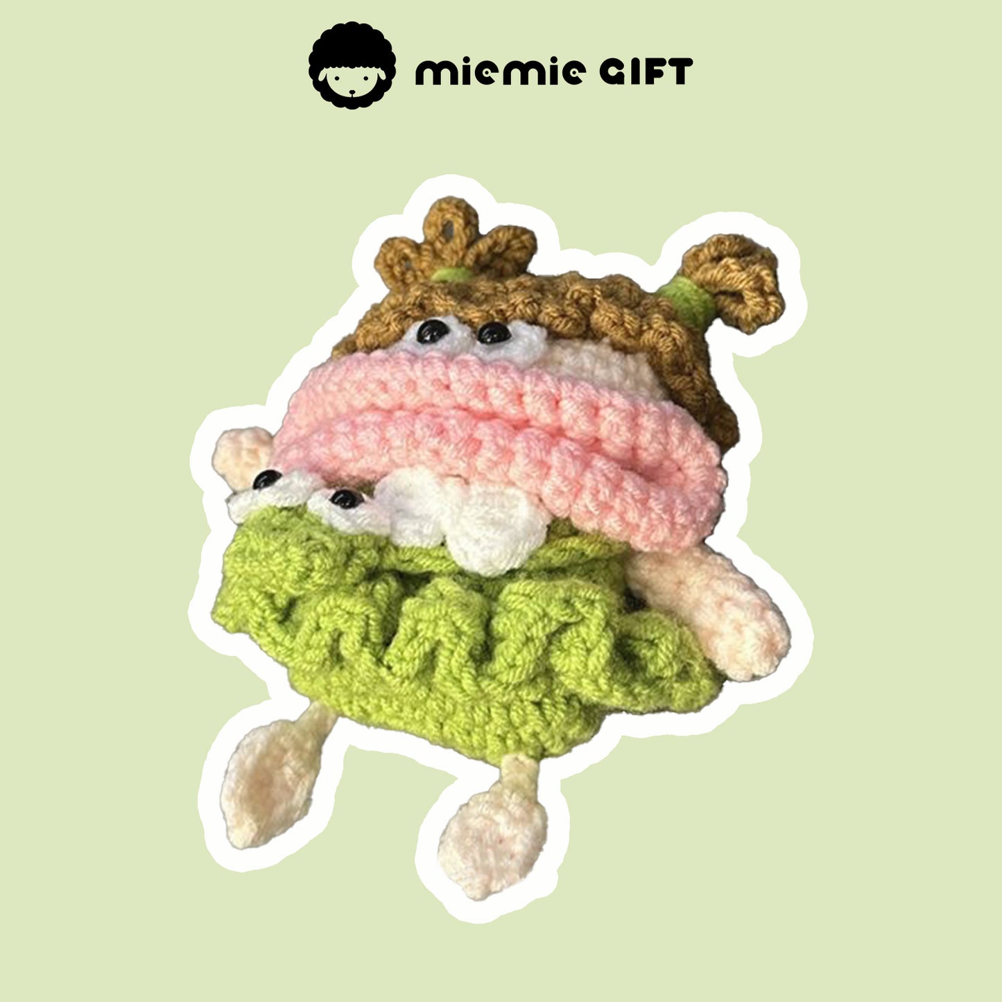 Front view of handcrafted knit earphone case featuring a playful design with curly brown hair, a pink scarf, and a green skirt. The case's adorable face with large eyes adds a whimsical touch while offering protection for your AirPods.