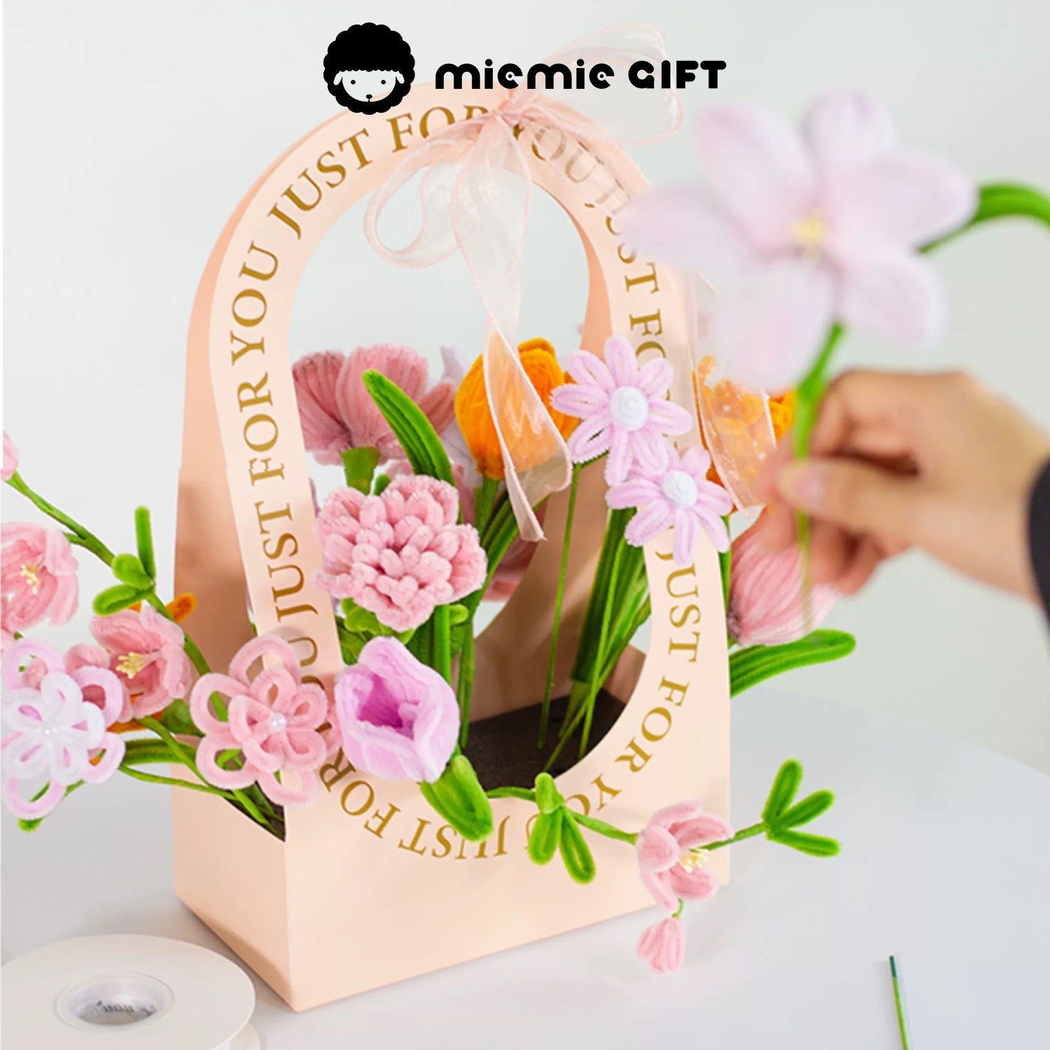 MieMie Gift DIY Flower Basket being creatively crafted, featuring handmade pipe cleaner flowers in pink and orange tones, ideal for personalized floral arrangements.