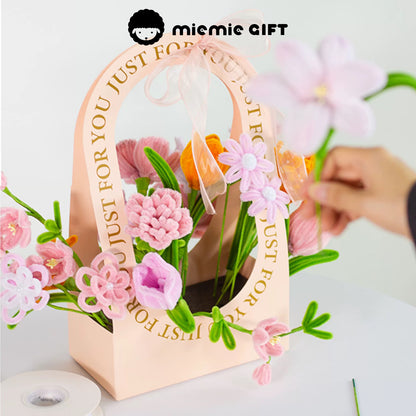 MieMie Gift DIY Flower Basket being creatively crafted, featuring handmade pipe cleaner flowers in pink and orange tones, ideal for personalized floral arrangements.