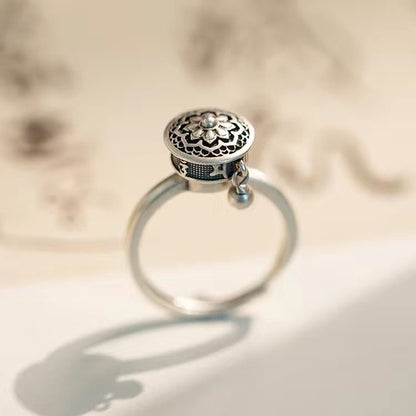 S925 sterling silver rotatable ring featuring a detailed lotus flower design and a dangling charm, symbolizing blessings, mindfulness, and stress relief.