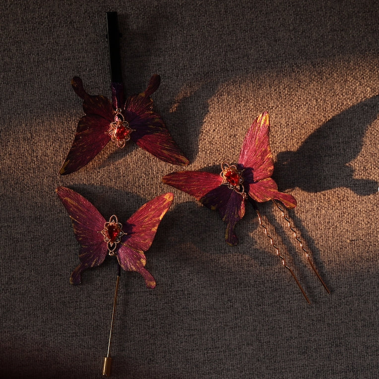 Set of handcrafted royal purple velvet butterfly accessories by Chujiu Mountain Atelier, featuring golden accents, red heart-shaped crystals, and versatile designs including hairpins, clips, and brooches.