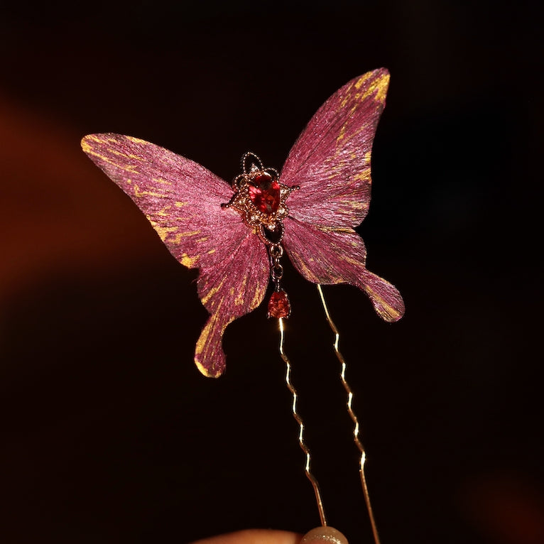 Elegant royal purple velvet butterfly decorative hairpin handcrafted by Chujiu Mountain Atelier, featuring golden accents, a radiant red heart-shaped crystal, and a delicate dangling charm, perfect for sophisticated styling.