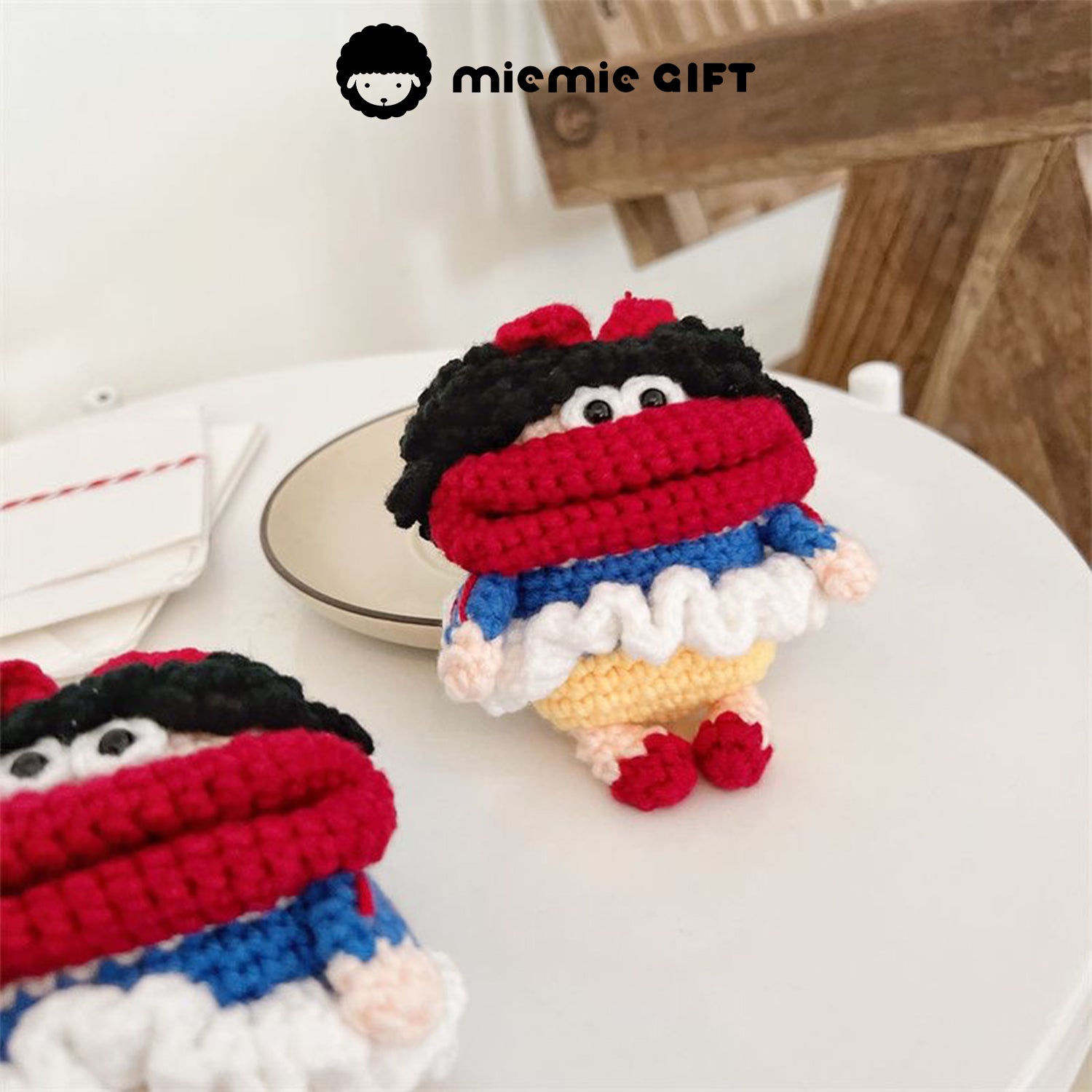 Snow White earphone case placed on a café plate, showcasing the fun design with bright red, blue, and yellow colors. The case adds a whimsical touch to your AirPods protection.
