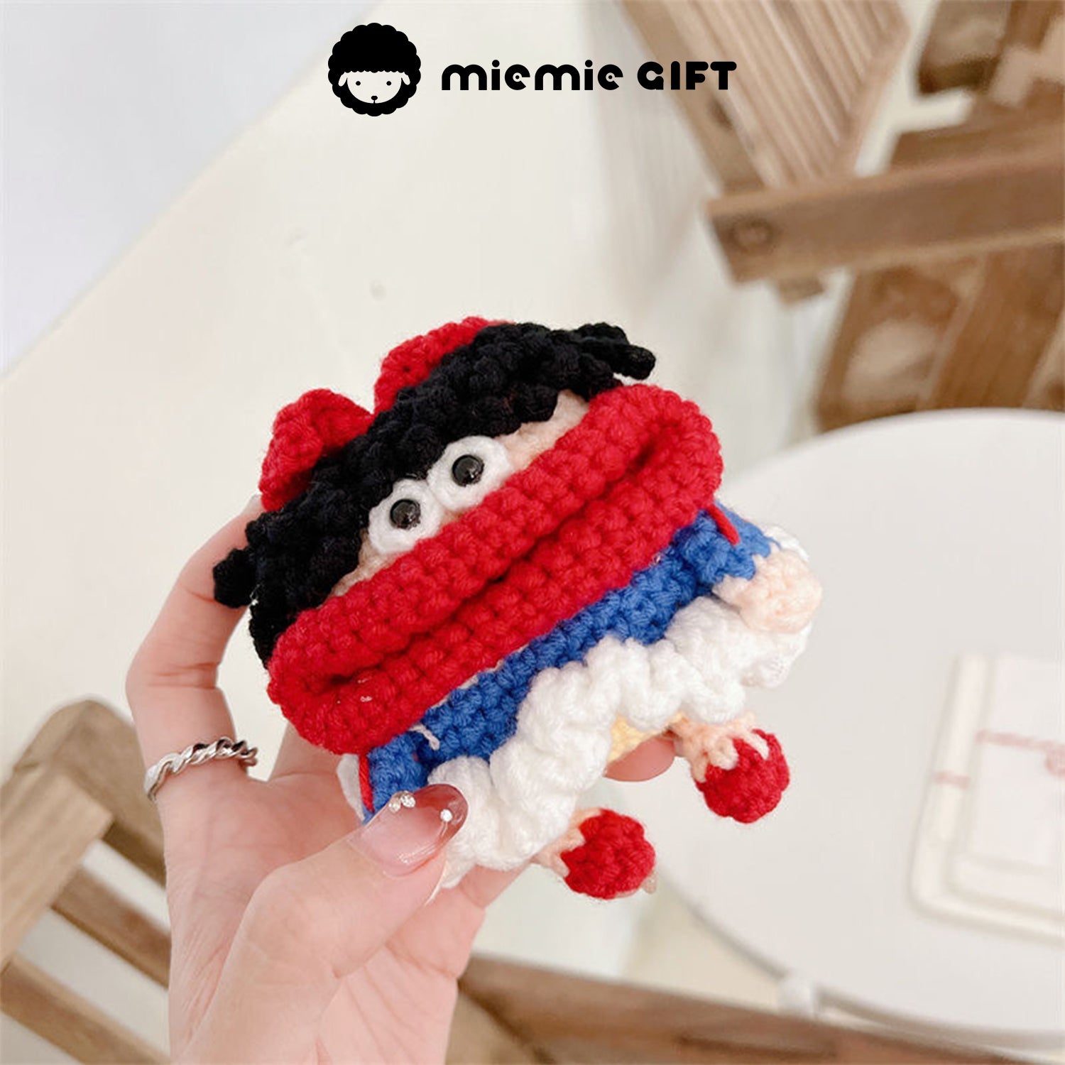  Close-up of Snow White earphone case held in hand, showing the colorful design with black curly hair, red bow, and a playful face. The case is perfect for protecting your AirPods while adding a whimsical touch.