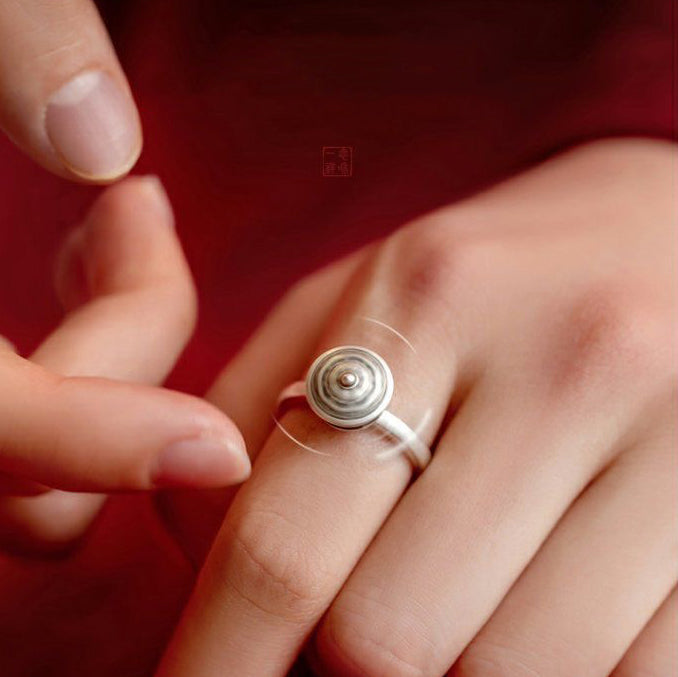 Person spinning a rotatable S925 sterling silver ring with smooth motion, showcasing the calming design for mindfulness and stress relief.