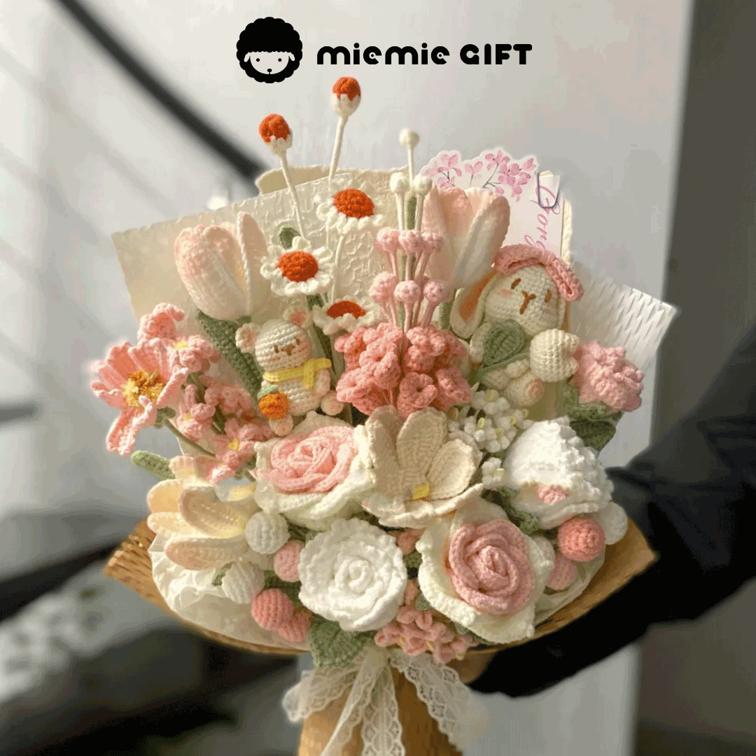 A beautifully handcrafted flower bouquet made of yarn featuring soft pastel tones of white pink beige and cream. The bouquet combines a variety of flowers and animals such as roses tulips chrysanthemums lily-of-the-valley animal doll like rabbit and bear meticulously woven with delicate details